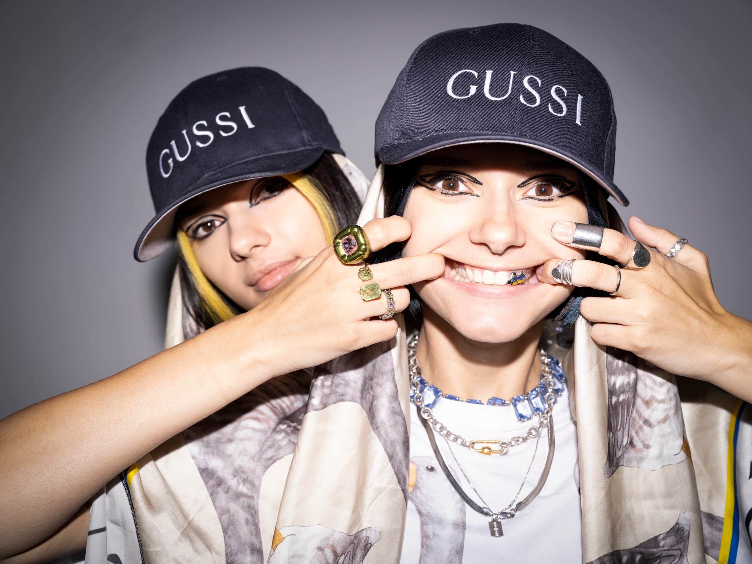 Bloom Twins in GUSSI caps and goose-print scarves